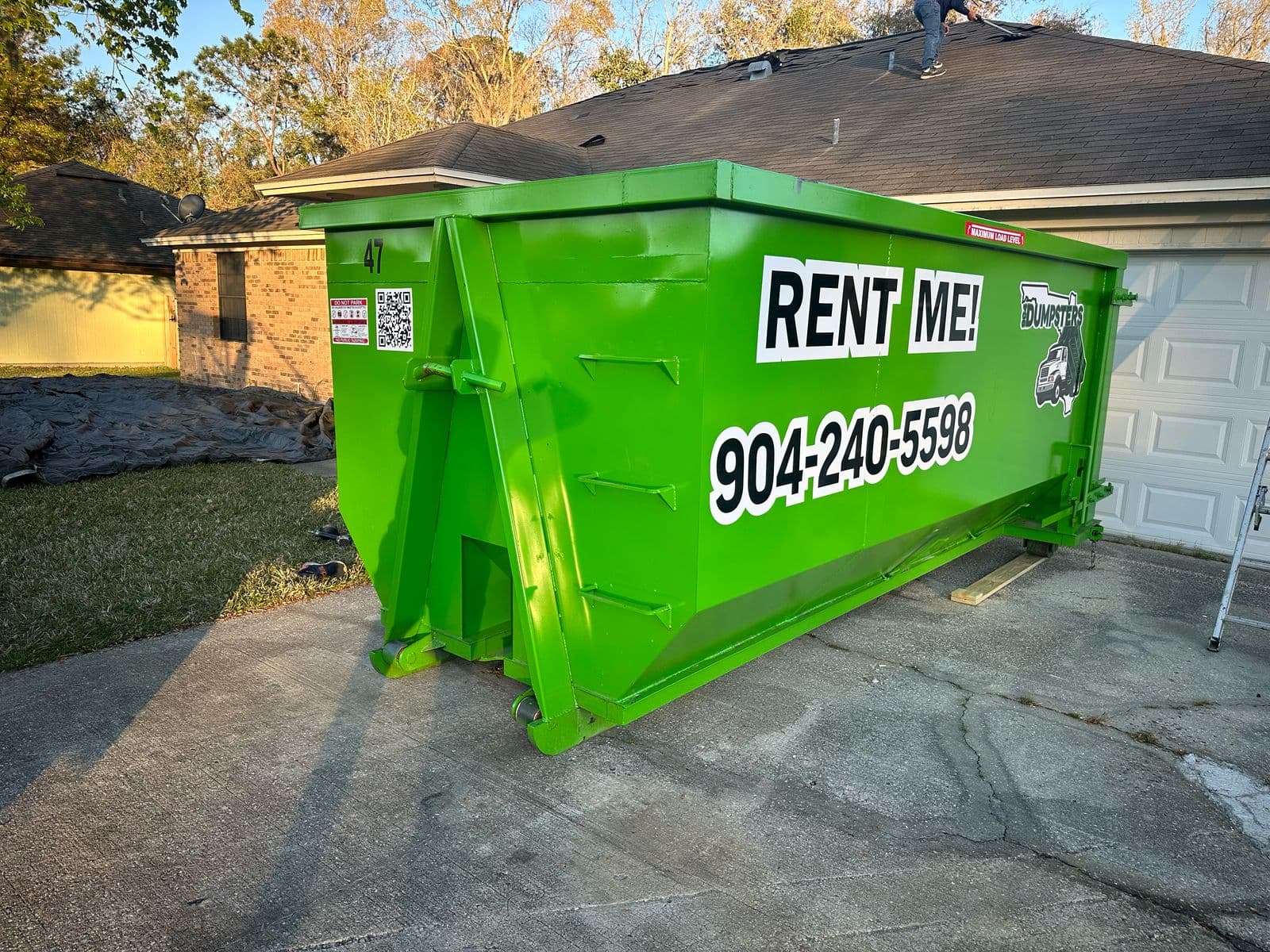 Dumpster rental delivery in Jacksonville FL - 904 Dumpster on residential driveway